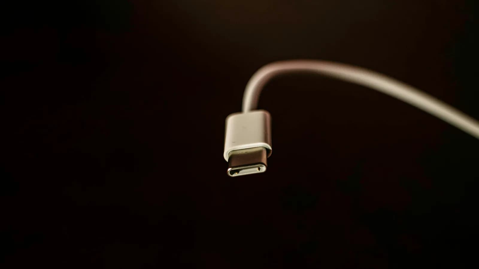 A white USB-C cable against a dark background